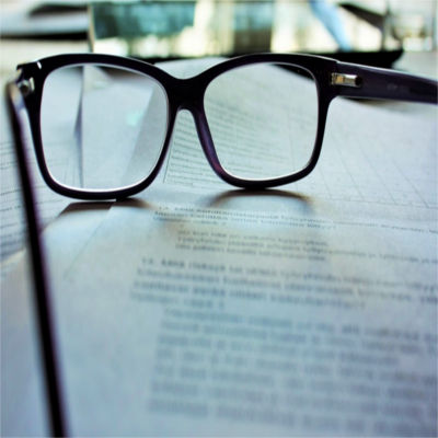 A pair of aeading glasses resting on a book