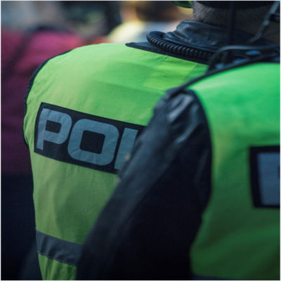 The backside of two police officers in uniform