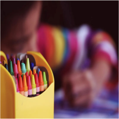 A child coloring with crayons