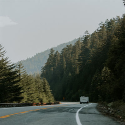 A camper driving down the road