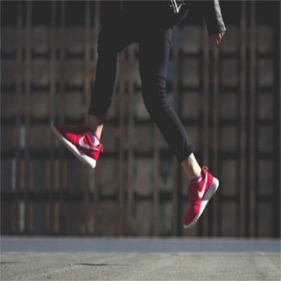 A person's feet jumping off the ground