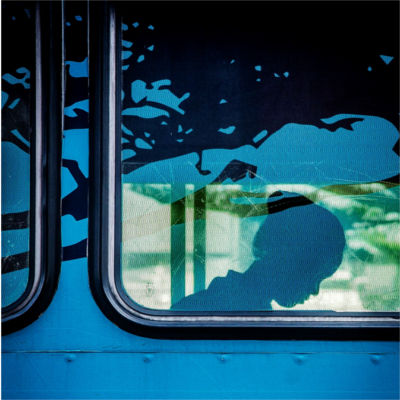 Silhouette of a person in a bus window