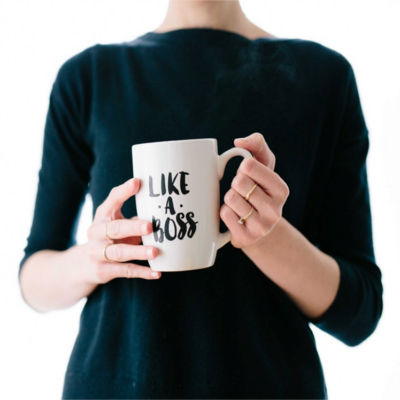 A person holding a cup that says "Like a Boss"