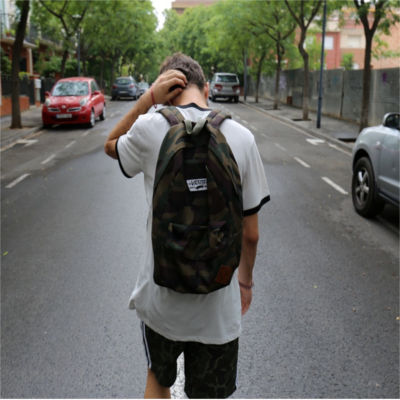 A person walking down the street wearing a backpack