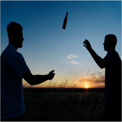 People throwing a bottle in the air