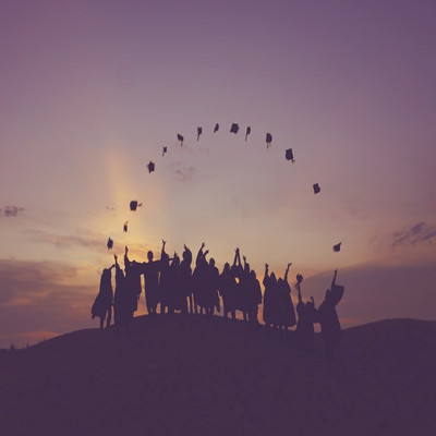 A group of people outside at sunset