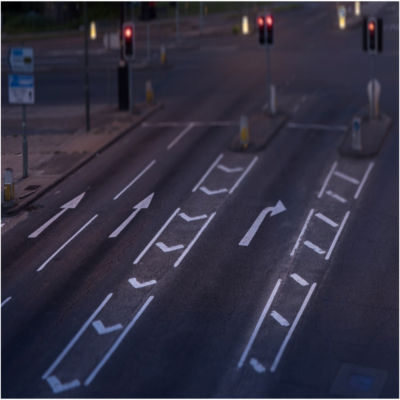 A birds-eye view of an empty street with all red lights