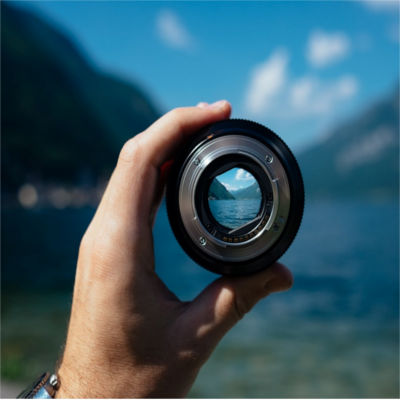 A person holding a magnifying glass