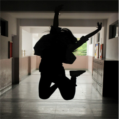 A person jumping in a school hallway