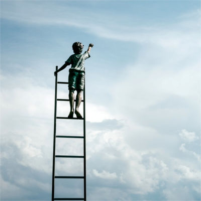 A child at the top of a ladder, reaching toward the sky